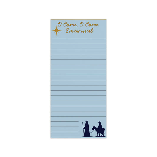 Light blue notepad with gold text reading “O Come, O Come Emmanuel,” a gold star at the top, and a navy silhouette of Mary and Joseph with a donkey at the bottom.