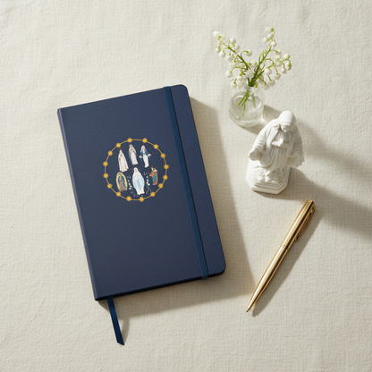 Styled flat-lay of Blessed Virgin Mary hardcover journal with Mary statue and flowers