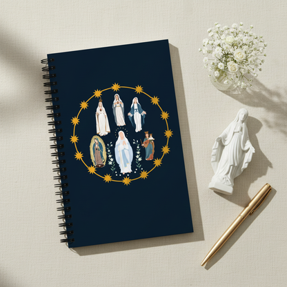 Styled flat-lay of Blessed Virgin Mary notebook with Mary statue and flowers